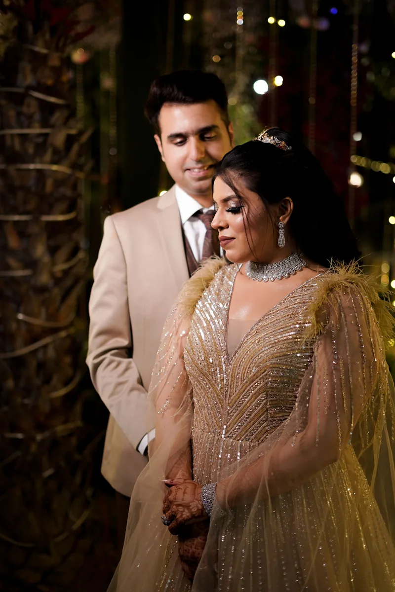 Indian wedding couple in a gold and neutral portrait — illustrative stock photograph